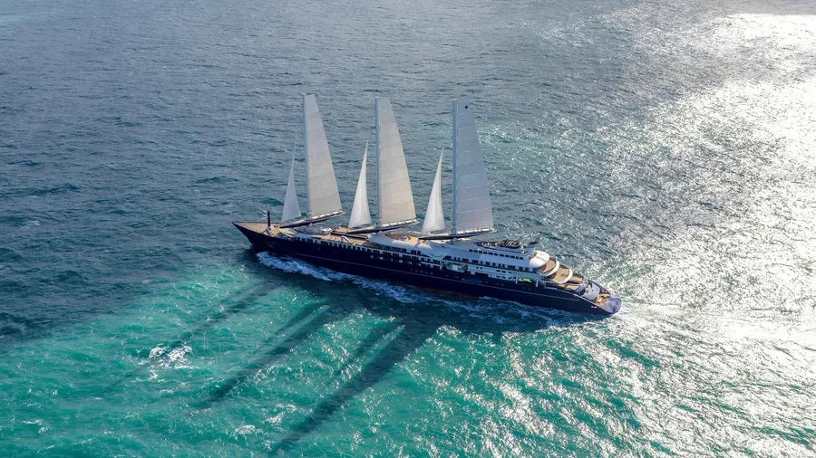 Orient Express Corinthian under her three rigid sails on a turquoise sea