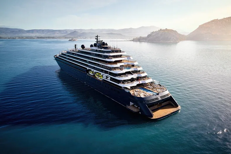 Evrima of The Ritz-Carlton Yacht Collection off a mountainous coast